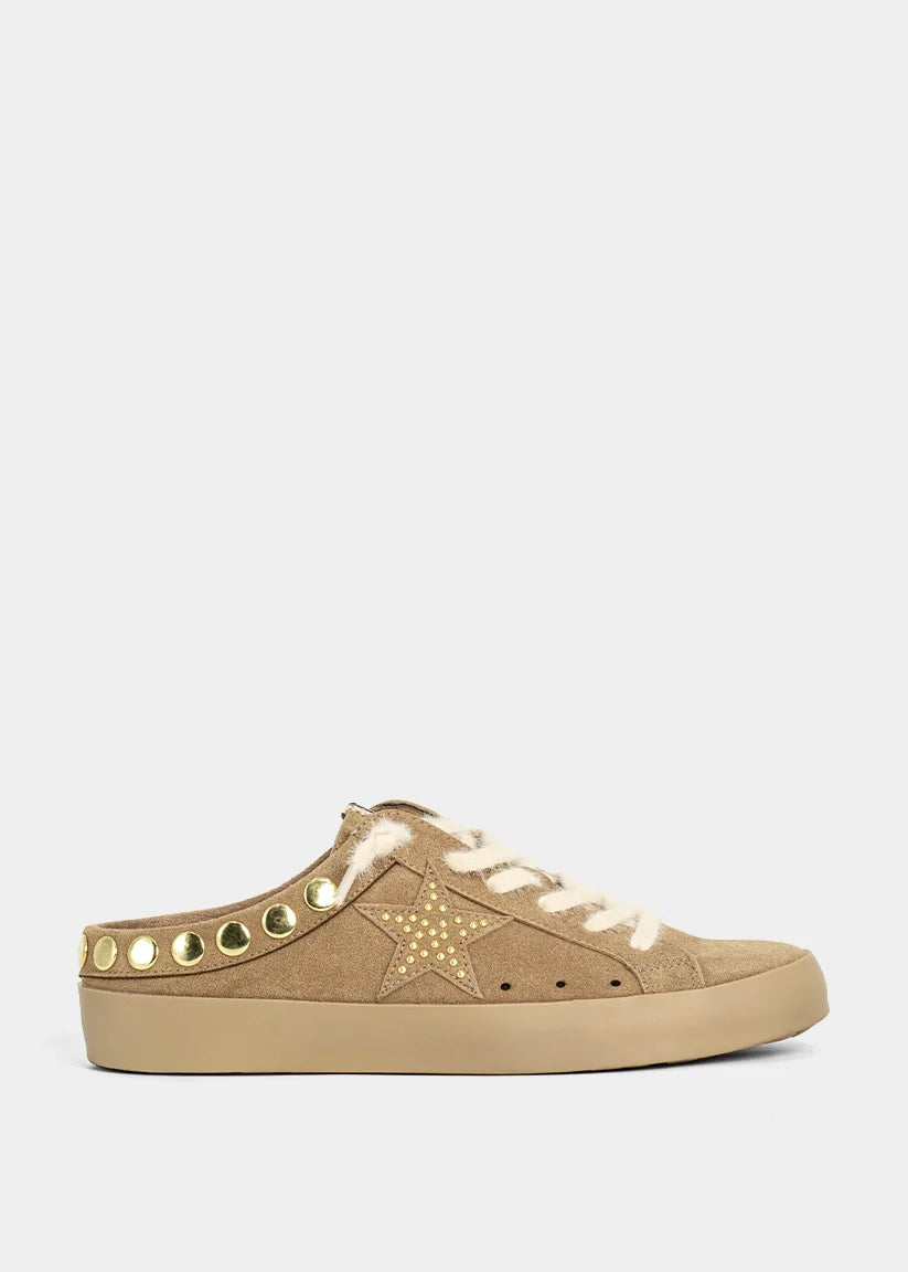 Camel suede backless sneakers with metallic studs, star details, and textured laces.