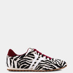 Zebra-print hair sneakers with burgundy accents and gum sole.