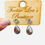 Water-resistant silver teardrop earrings with sparkling crystal studs and glossy reflective charm.