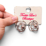 Silver wire rose stud earrings with looping petals and polished silver bead centers.