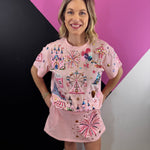 Pink top and skort set with colorful sequin amusement park graphics and gold lettering.