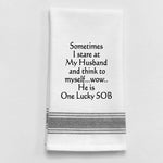White tea towel with black trim and funny husband quote.