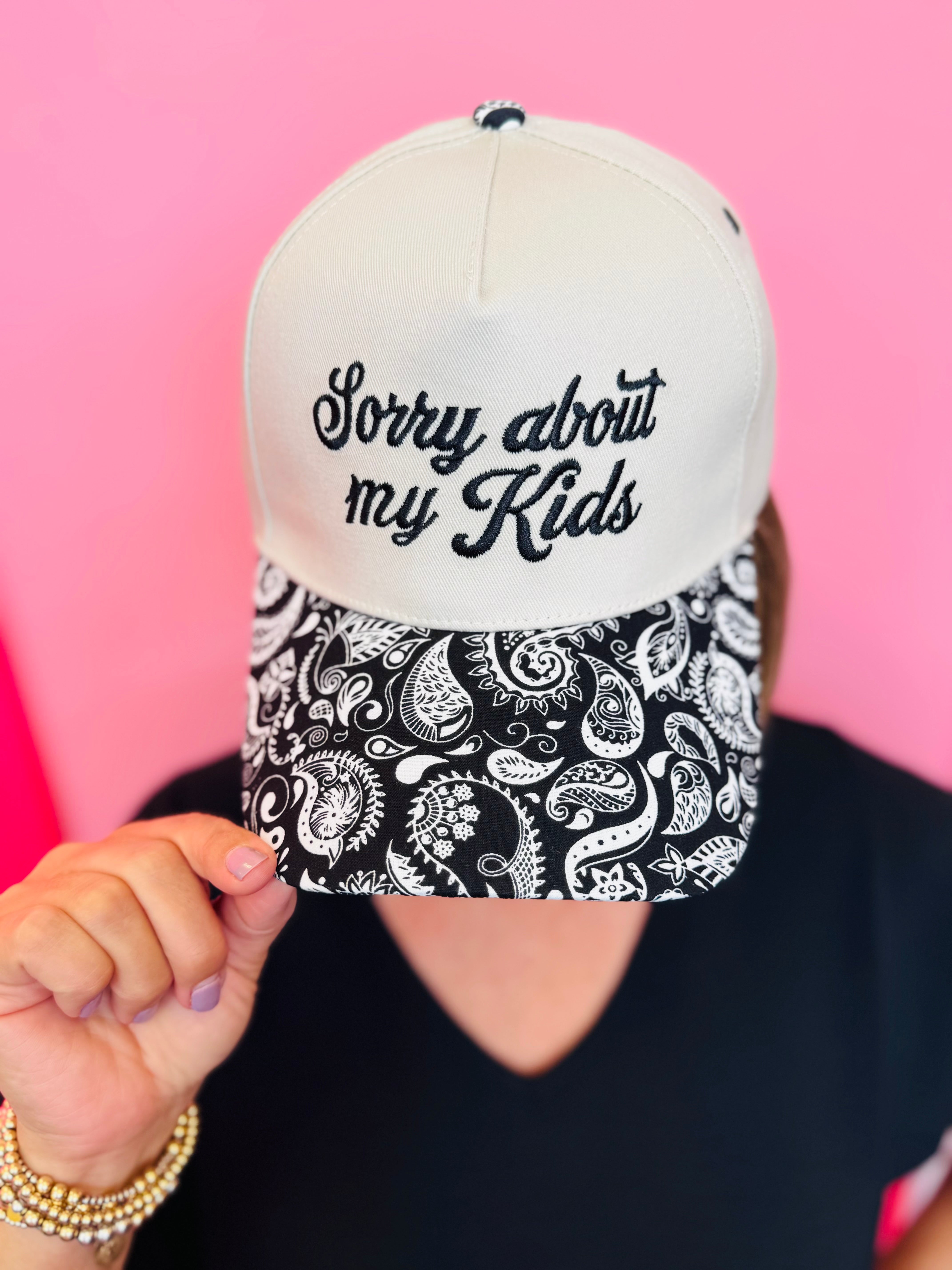 Two-tone snapback hat with Sorry About My Kids embroidery and black white paisley bill