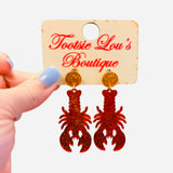 Red glitter lobster earrings with gold glitter stud tops.