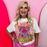Cream graphic tee with spoiled leopard, crown, colorful artwork, and rhinestone embellishments.