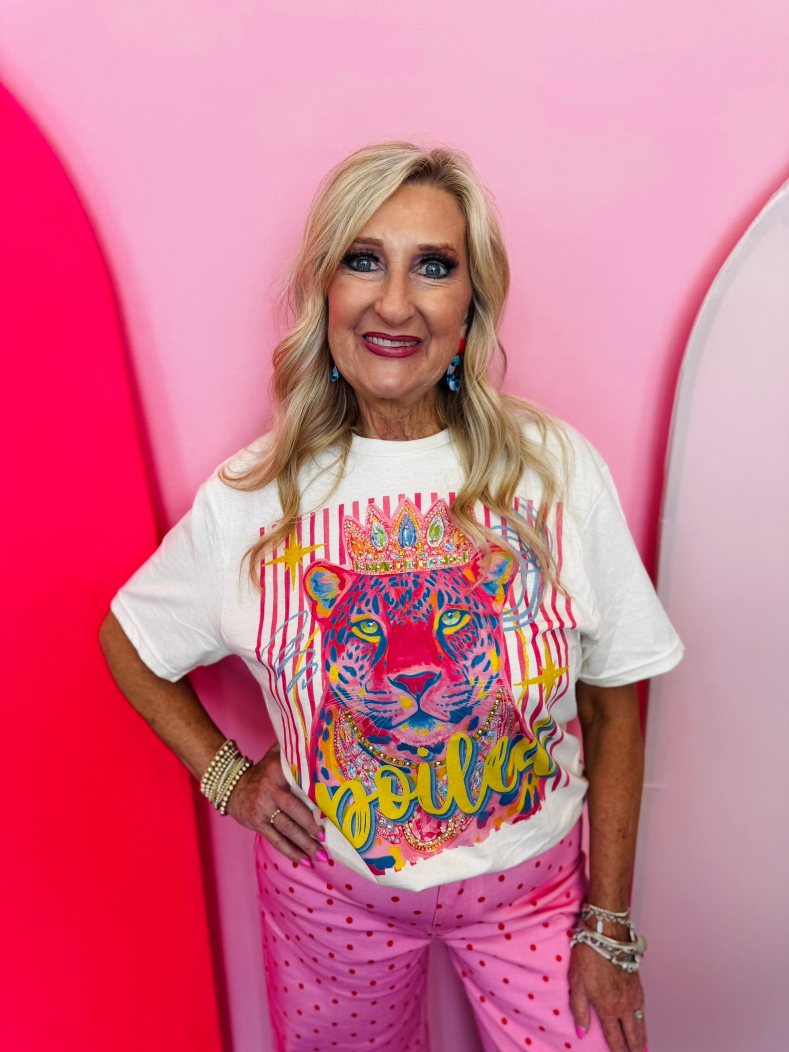 Cream graphic tee with spoiled leopard, crown, colorful artwork, and rhinestone embellishments.