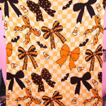 Halloween blanket with bows, bats, candy corn and checkerboard accents.