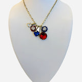 Gold and silver necklace with red blue crystal charm cluster