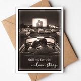 Romantic card with vintage drive-in movie scene and couple in convertible.