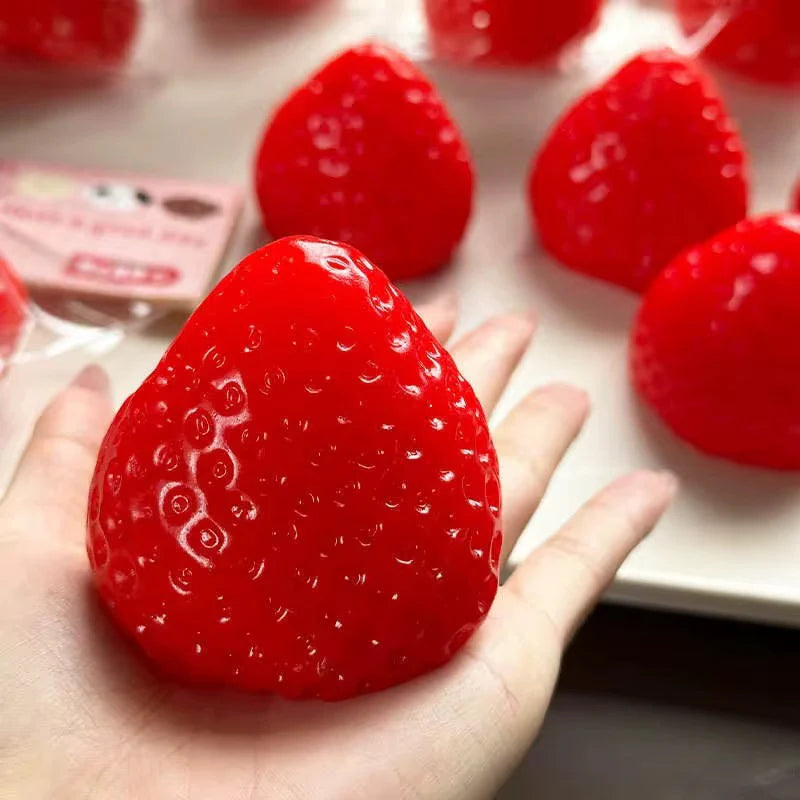 Strawberry-shaped squishy stress toy with soft sensory texture.