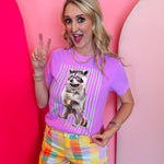 Purple tee with bling raccoon graphic wearing sunglasses and striped background.
