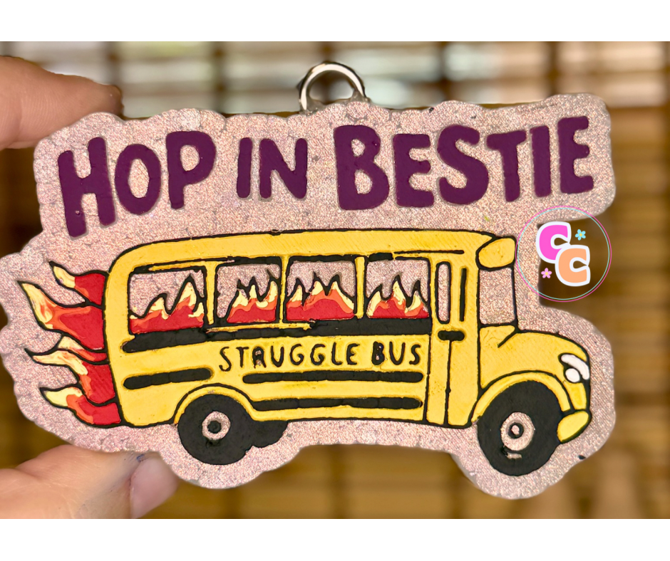 Struggle Bus freshie with flaming bus graphic and Hop In Bestie wording.