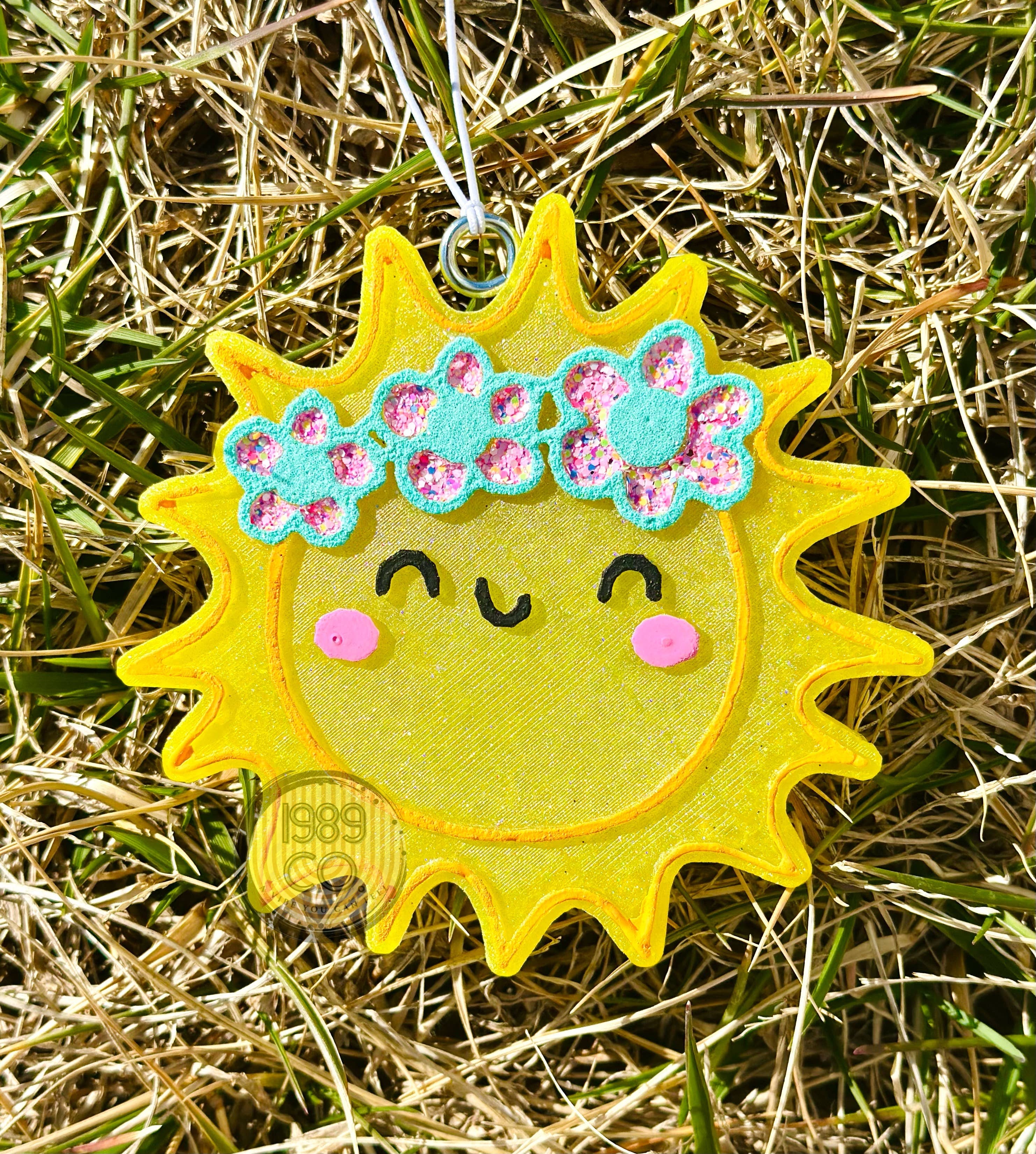 Sun shaped car freshie with hook and string hanging for fresh long lasting scent.