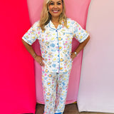 Two-piece brunch print pajama set with ruffle trim and tie waist.