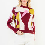 Burgundy mock neck sweater with abstract blush and golden intarsia pattern in soft knit fabric.
