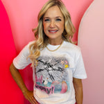 White graphic tee with beach scene, colorful icons, and rhinestone accents