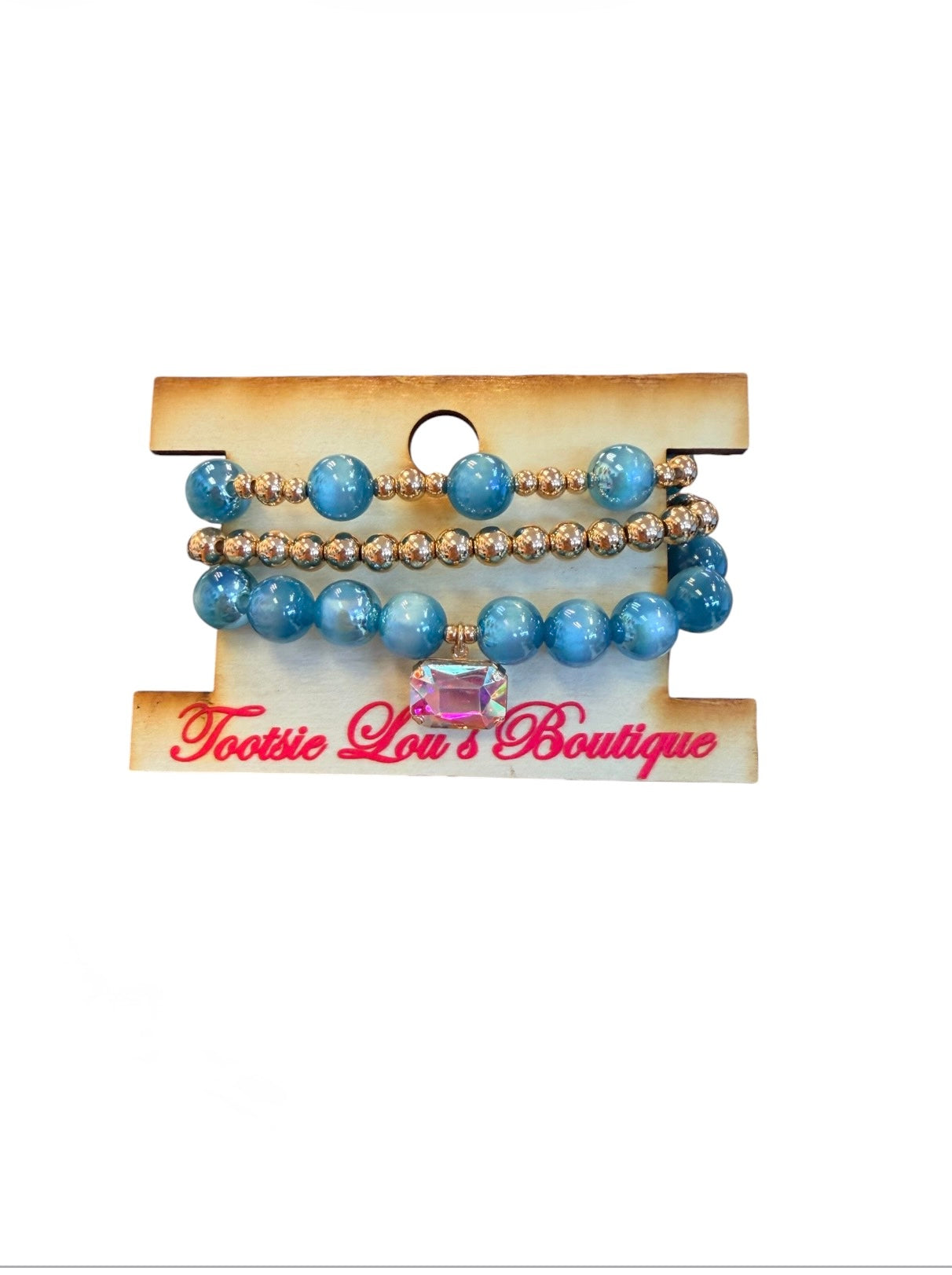 Teal blue beaded stretch bracelet set with gold accents and crystal charm.