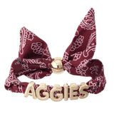 Texas A&M bandana slider bracelet with gold AGGIES letter charms and adjustable fabric band.