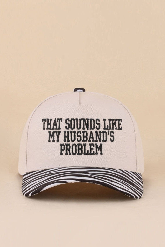 Two-tone zebra hat with That Sounds Like My Husband's Problem embroidered saying.