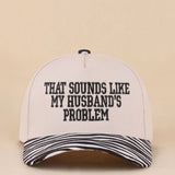 Two-tone zebra hat with That Sounds Like My Husband's Problem embroidered saying.