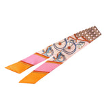 Vibrant travel silk scarf tie with oranges, pinks, golds, geometric patterns, and polka dot ends.