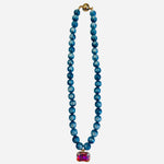 Turquoise beaded necklace with rectangular crystal charm and iridescent candy beads.