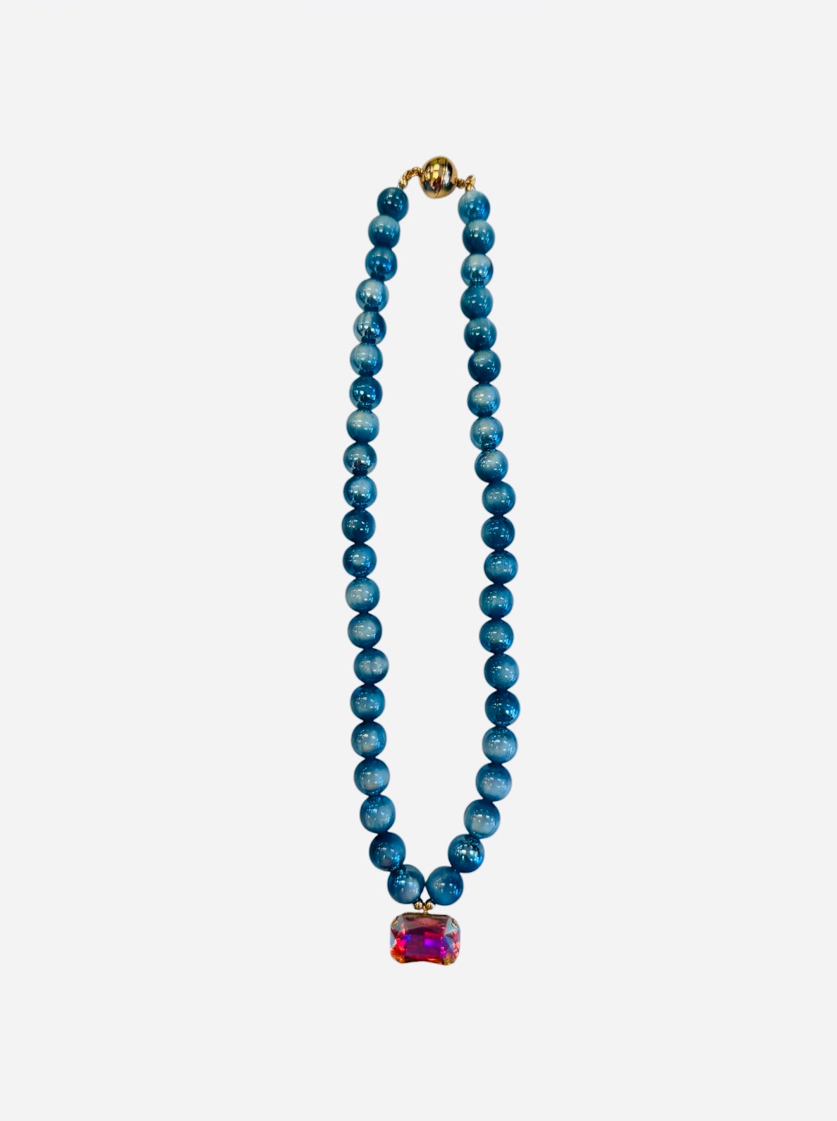 Turquoise beaded necklace with rectangular crystal charm and iridescent candy beads.