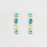 Teal and turquoise crystal drop earrings with cascading faceted stones and elegant dangle design.