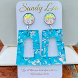 Turquoise open rectangle earrings with iridescent confetti accents and sparkling round studs.