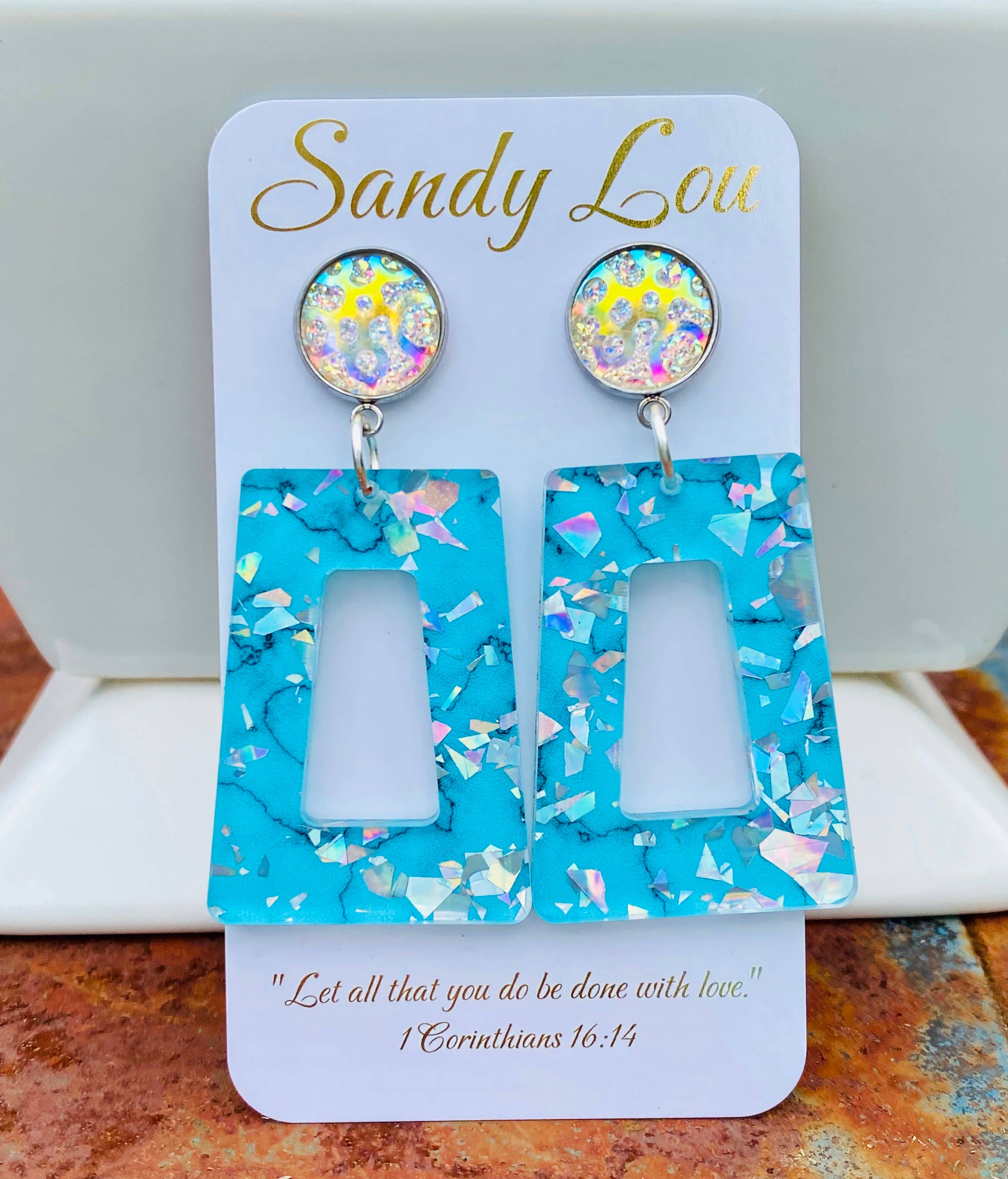 Turquoise open rectangle earrings with iridescent confetti accents and sparkling round studs.