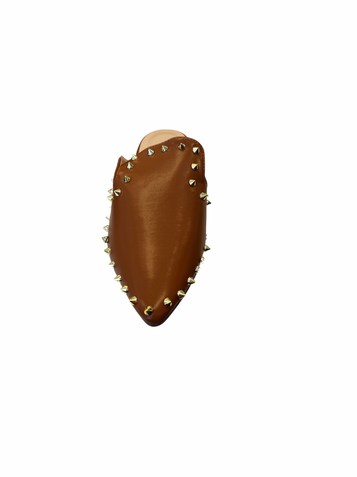 Camel-colored slide sandals with sleek silhouette and spikey stud embellishments along the edge