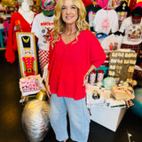 Magenta waffle knit V-neck top with raw-edge seam and cuffed 3/4 sleeves.