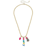 Gold beaded holiday necklace with Swarovski crystal snowman, pink Christmas light, and colorful “MERRY” word charm.