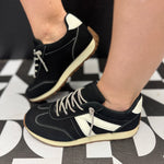 Black Very G sneakers with white accents, rhinestone laces, detailed stitching, and neutral sole.