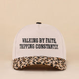 Two-tone leopard hat with Walking By Faith Tripping Constantly embroidered saying.