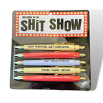 Five black pens featuring humorous sarcastic phrases from the Welcome To The Shit Show Pen Set.