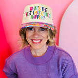 Cream multicolor “What’s the Best That Could Happen” hat with patchwork bill and star embroidery.