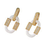 White enamel oval earrings with gold rhinestone hoops and geometric design.