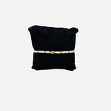 Gold filled bracelet with white Czech glass beads and stretch fit design.