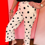 White straight leg ankle pants with bold black polka dots.