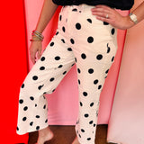 White straight leg ankle pants with bold black polka dots.