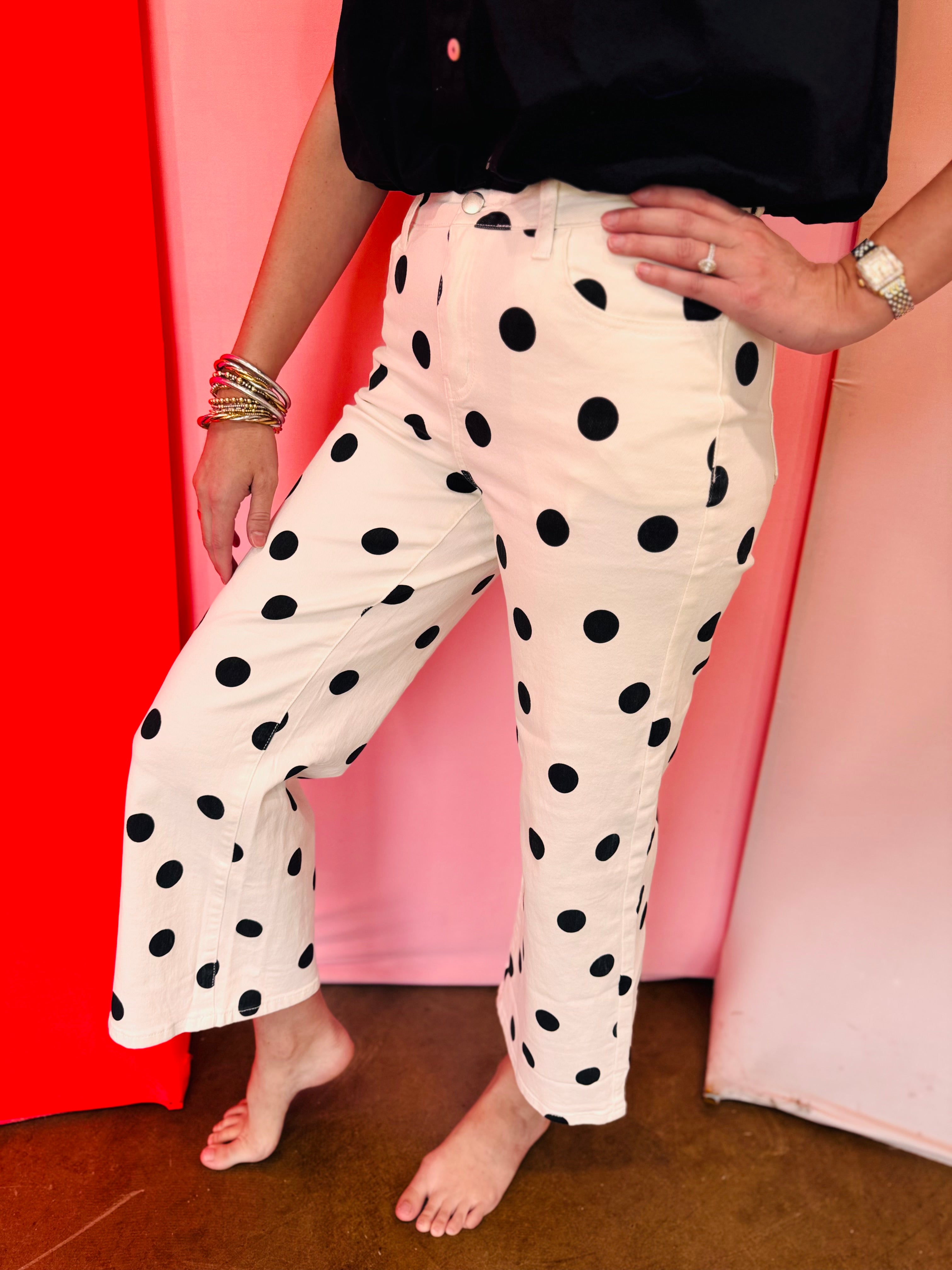 White straight leg ankle pants with bold black polka dots.