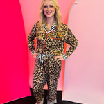 Leopard print pajama set with button-up top, striped trim, wide-leg pants, and elastic waistband