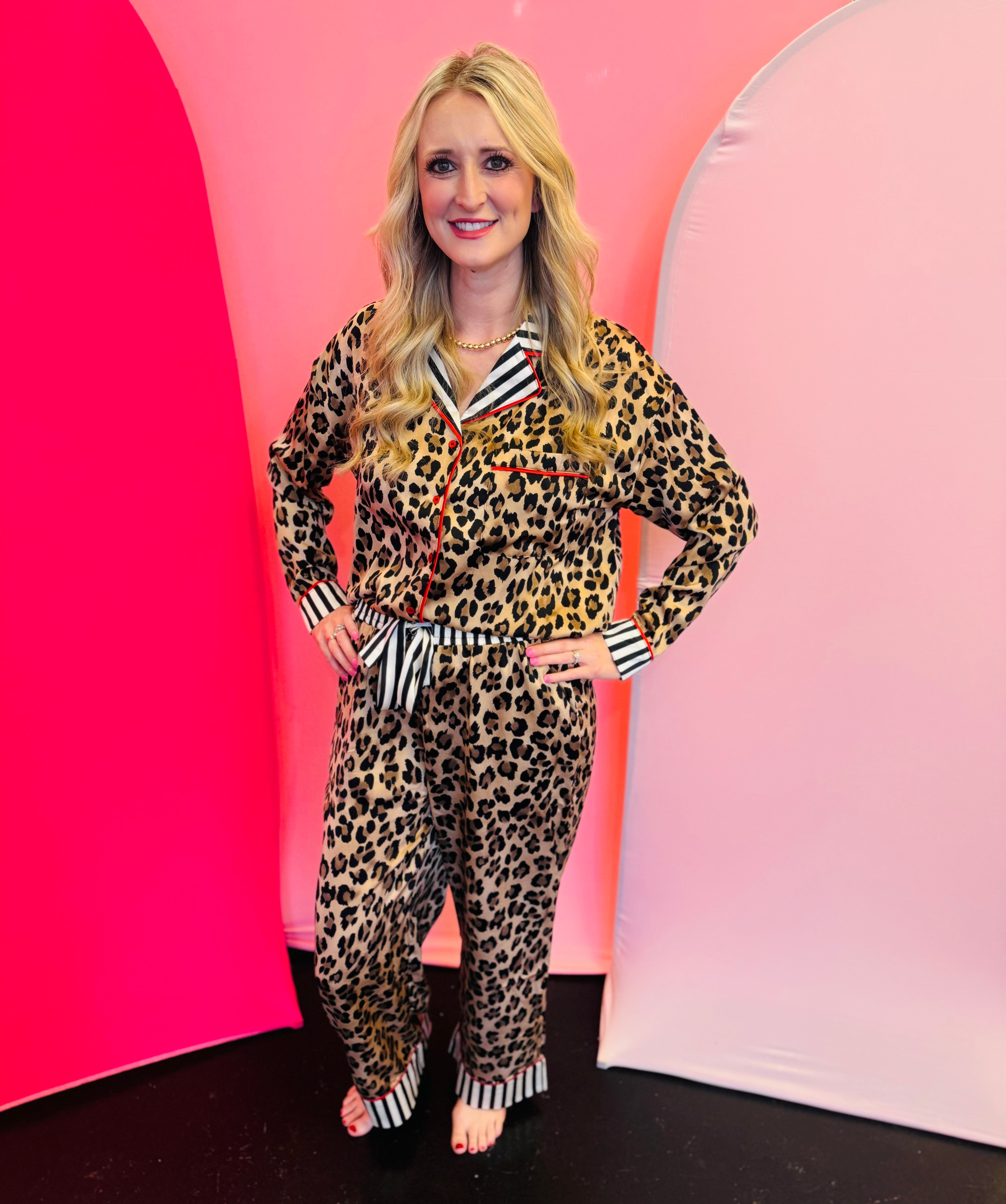 Leopard print pajama set with button-up top, striped trim, wide-leg pants, and elastic waistband