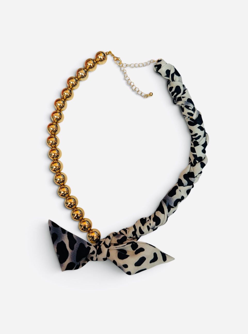 Gold ball bead necklace with leopard print scarf, tied bow accent, and adjustable chain.