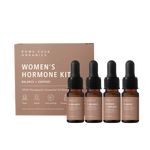 Balanced Hormone Essential Oil Kit with four 10ml roll-ons labeled E-Balance, P-Boost, T-Balance, and Thyroid + Adrenal Support, displayed upright next to the product instruction insert