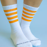 Orange striped athletic-style crew socks with soft cotton blend and cozy stretch fit