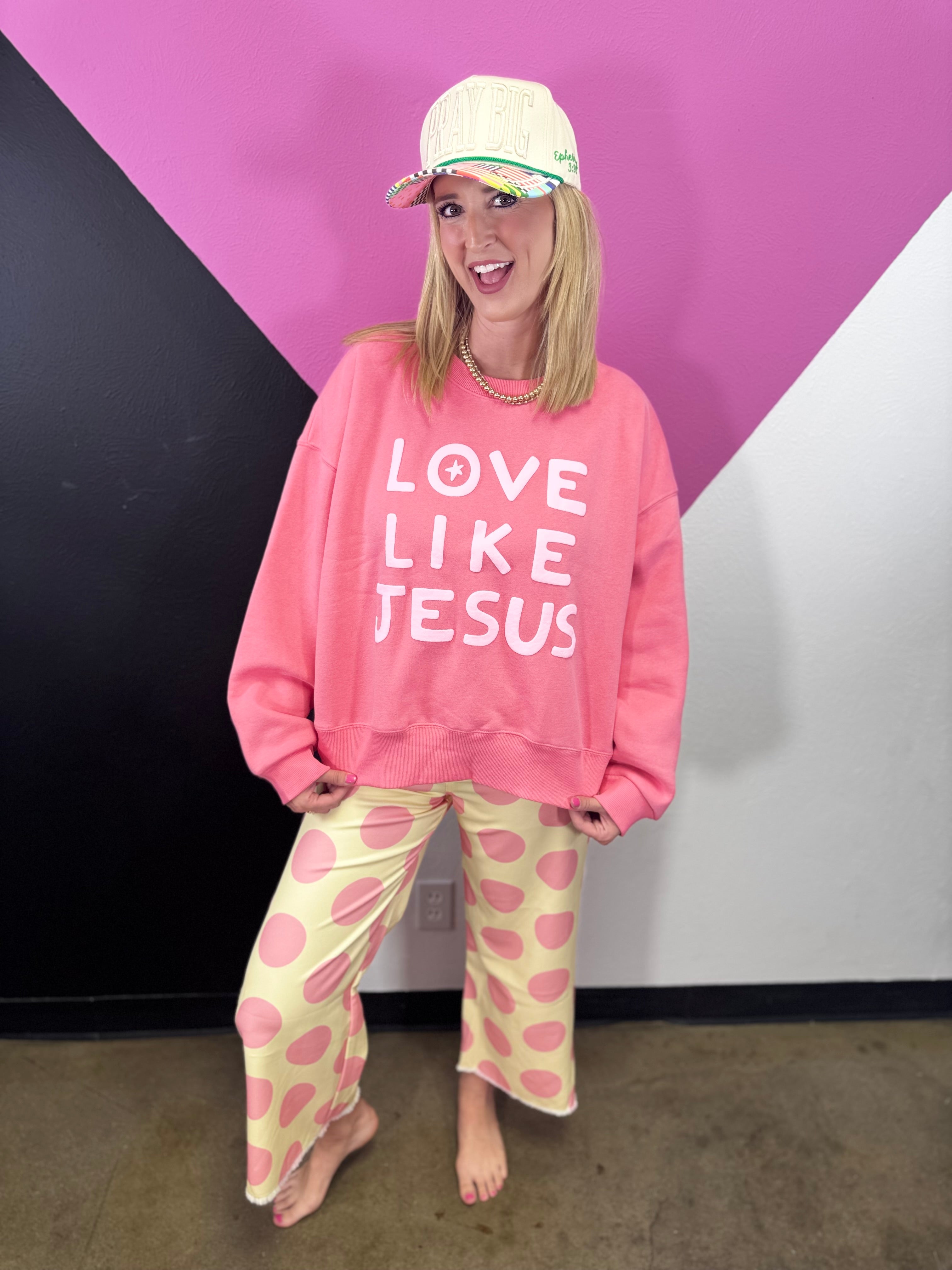 Yellow straight-leg pants covered in oversized pink polka dots.