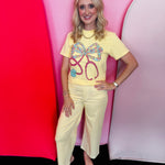 Butter yellow Comfort Colors tee with floral bow stethoscope graphic and colorful accents