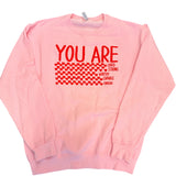 Light pink crewneck sweatshirt with red “you are” graphic and tiny heart details